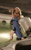 Kristen Bell with a bottle of whisky looks to be drunk in the fountain filming When in Rome
