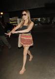 Amanda Bynes shows legs in short skirt as she arrives at LAX airport in Los Angeles
